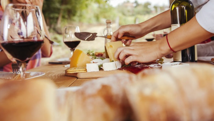 people eating wine and cheese